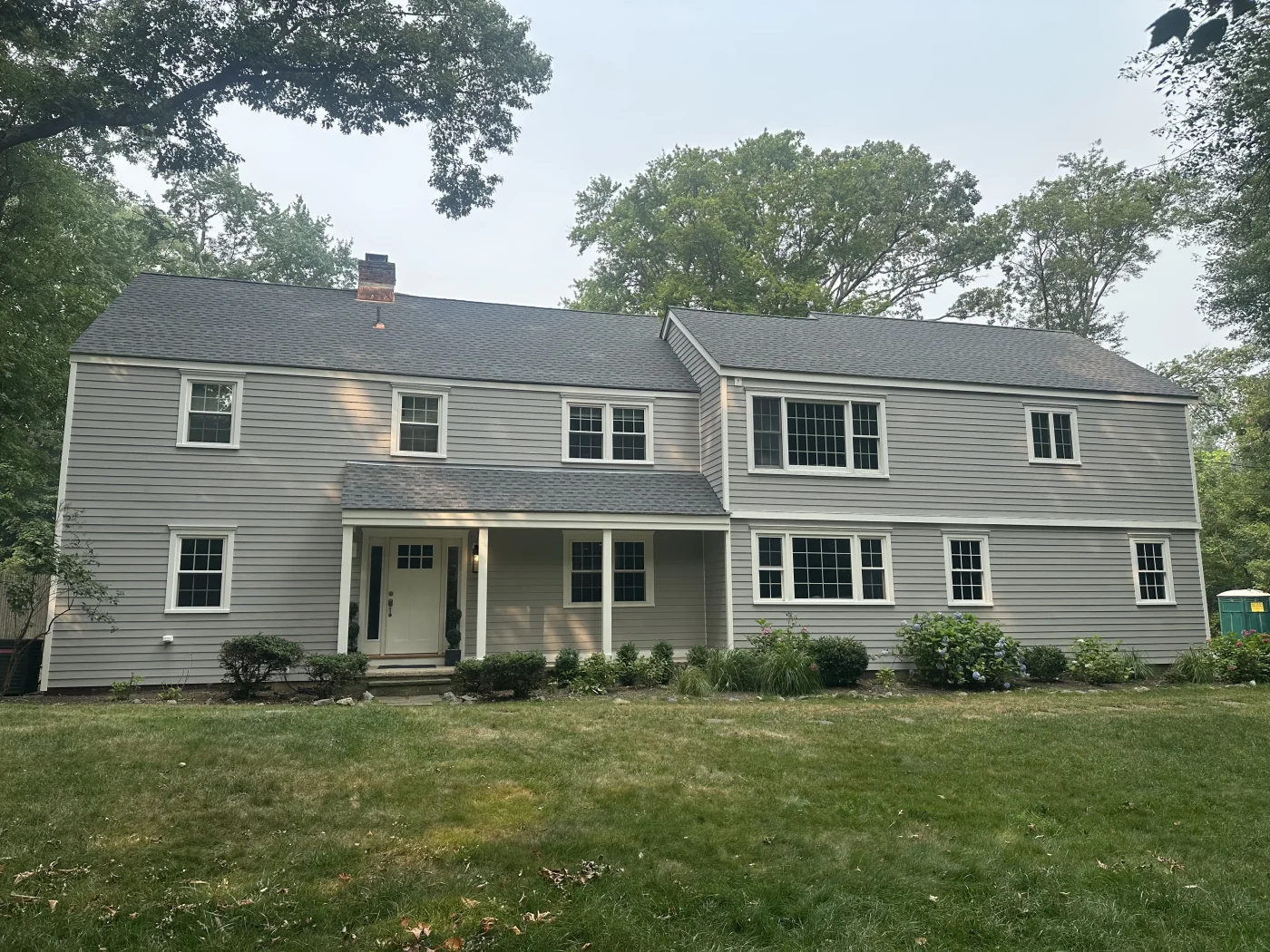 A two-story home with new fiber cement siding installed on it.