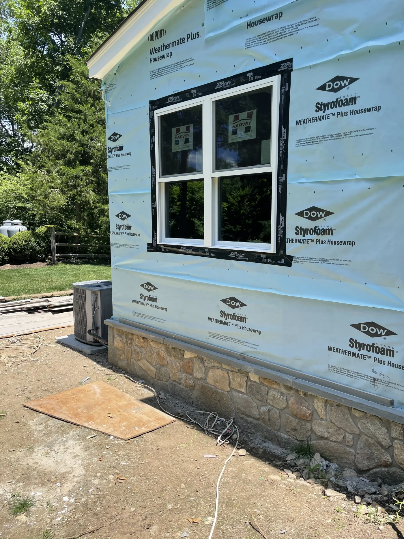 A close-up view of a home that is having new siding installed, starting with the bottom layer.
