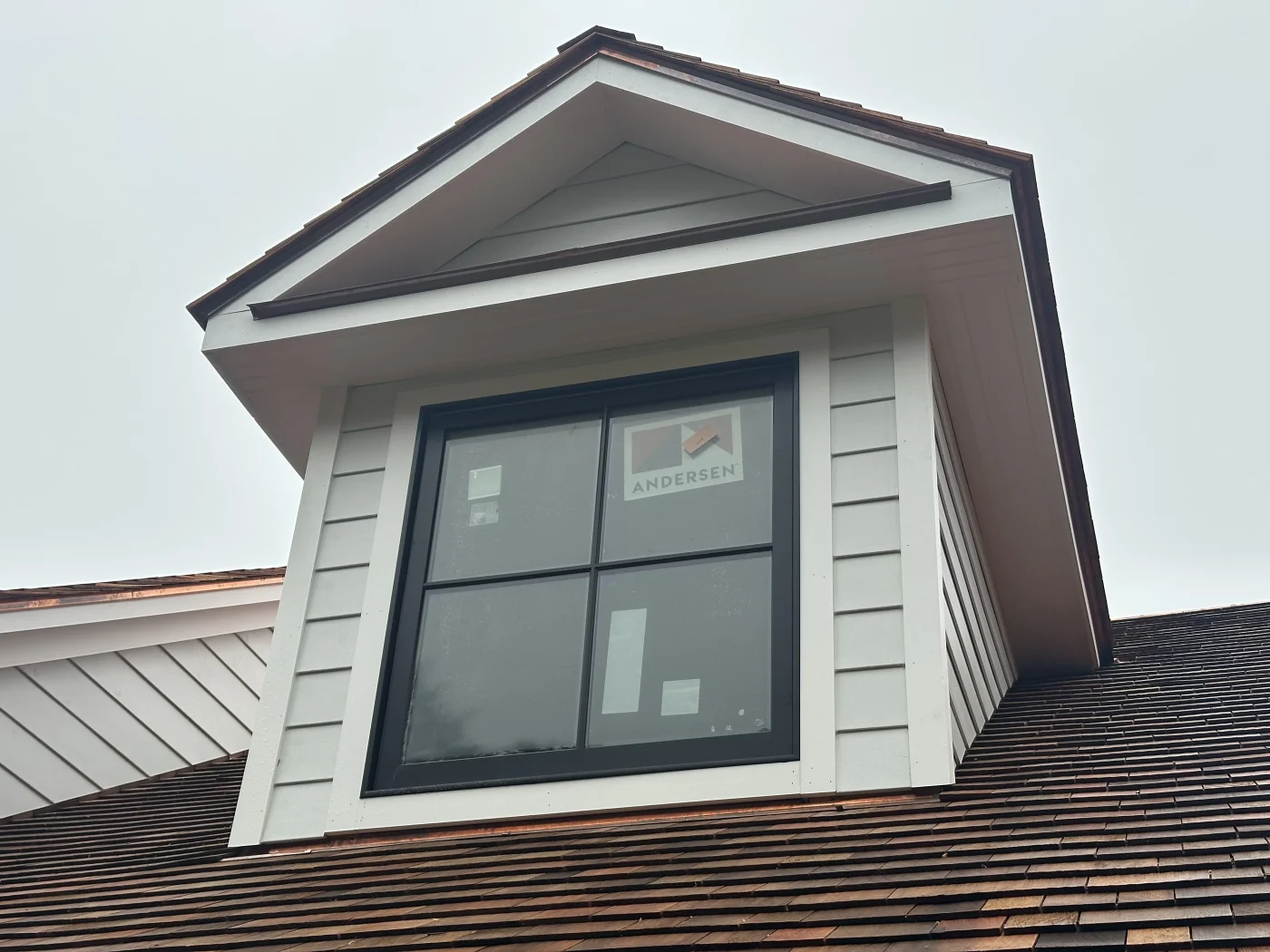 A newly installed double-hung window with clean insulated trim on a beautiful home.