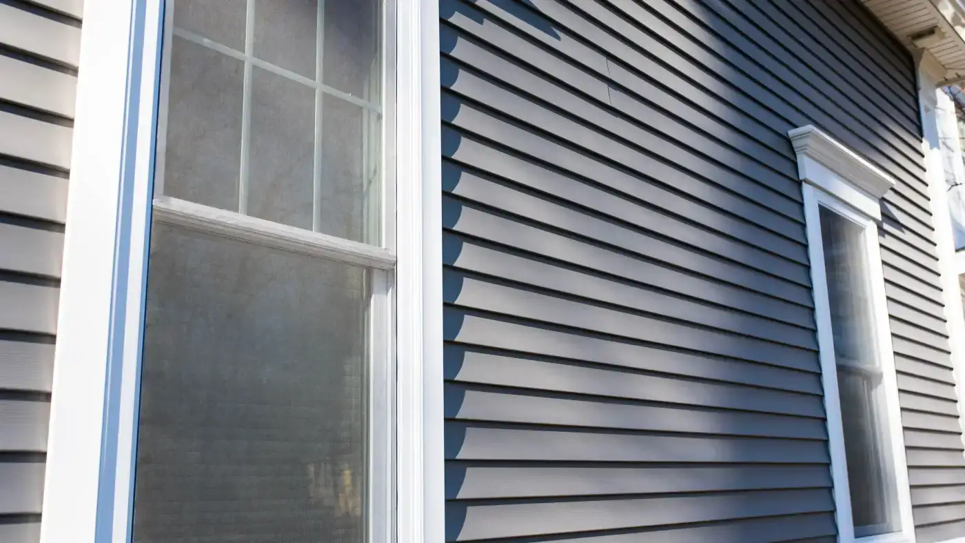 Cost-Effective Harvey Vinyl Windows | Fairfield County, CT | Sound Renovation An angled exterior view of two newly installed vinyl windows on a traditional local home.