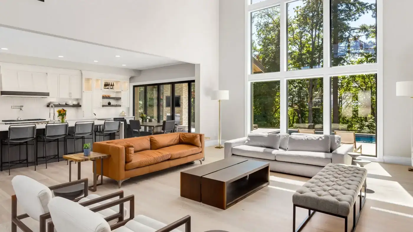 Exceptional Marvin Windows | Fairfield County, CT | Sound Renovation An interior view of a beautiful upscale living room with a two-story window wall installed on its far side.