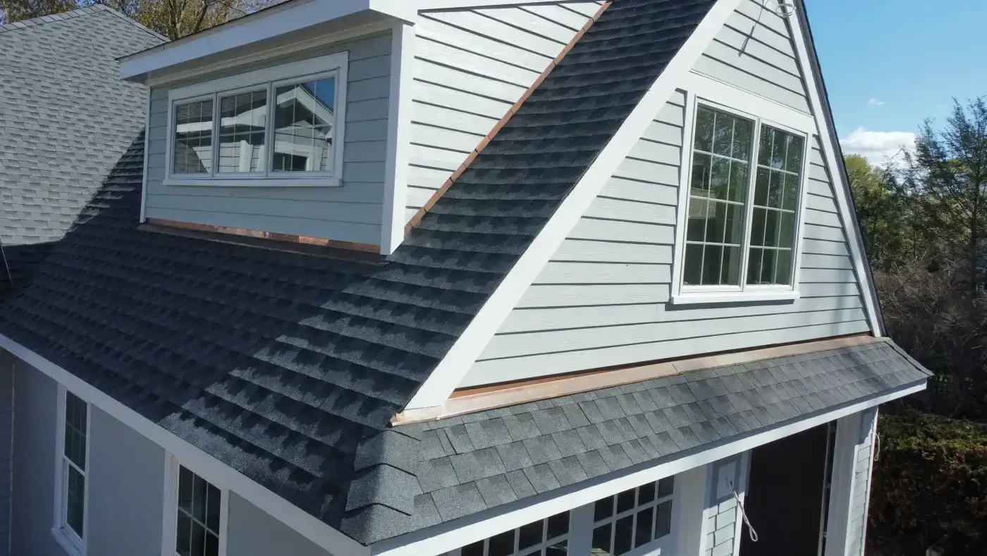 Exceptional Roofing Materials Of All Types | Fairfield County, CT | Sound Renovation A close view of the beautiful asphalt roofing and copper flashing installed on a local home.