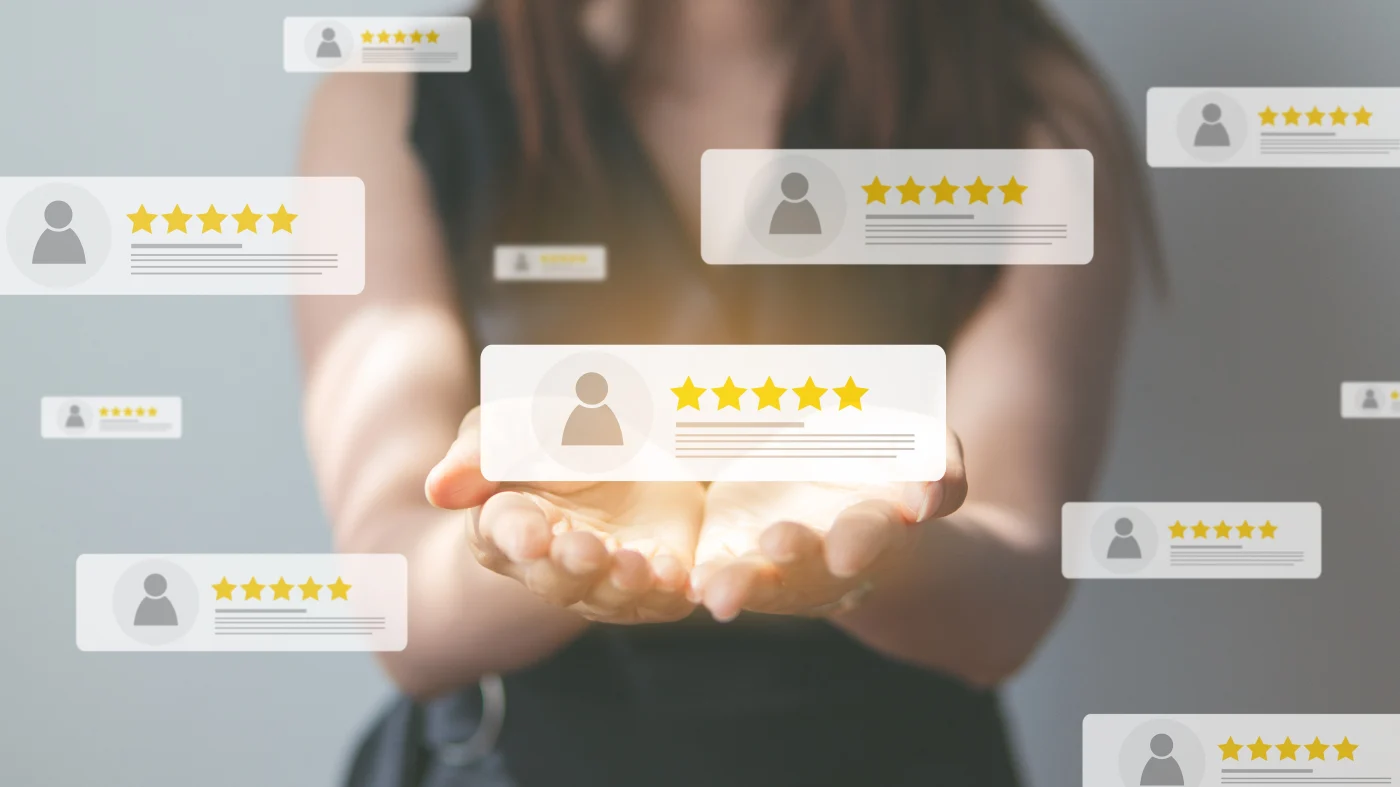 A close frontal view of a woman extending her hands in front of her, palms up. Hovering over her hands and around her are a bunch of graphics representing 5-star customer reviews.