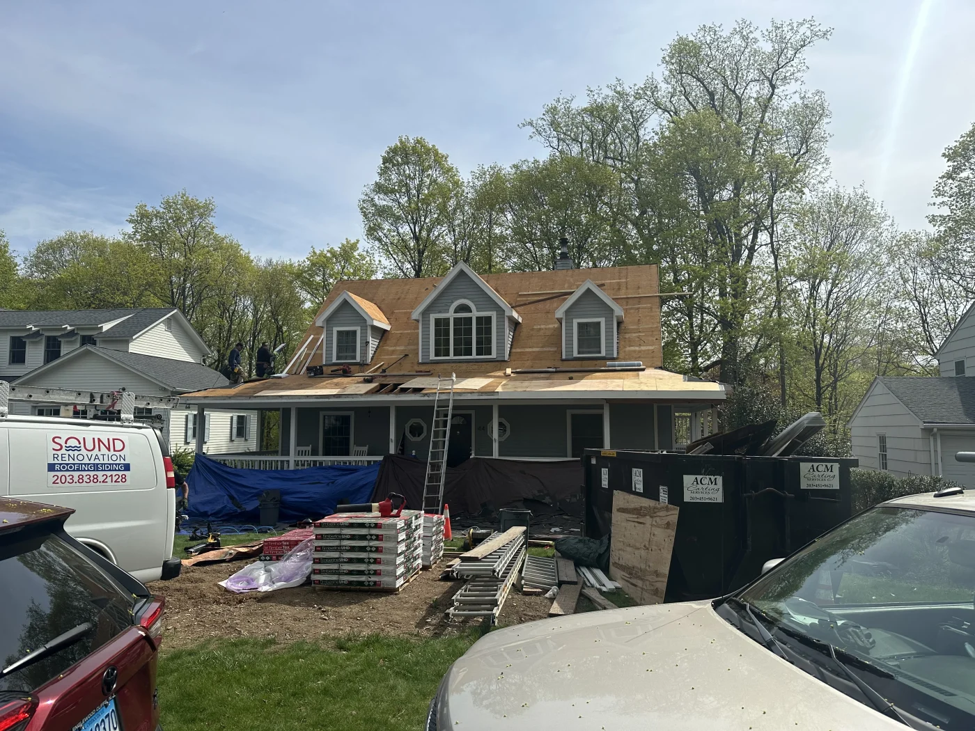 A home that is currently undergoing a roof replacement with the old roof already removed.
