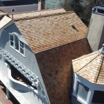An angled, elevated view of the beautiful cedar shingles installed on a local home by Sound Renovation.