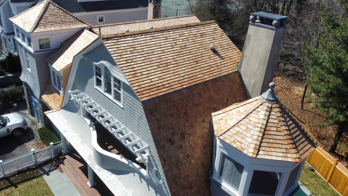 An angled, elevated view of the beautiful cedar shingles installed on a local home by Sound Renovation.