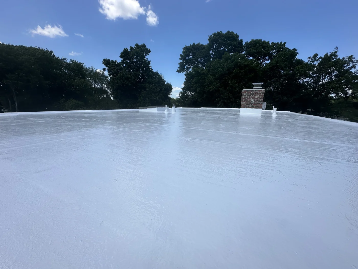A white, flat roof system that is installed on a commercial building.