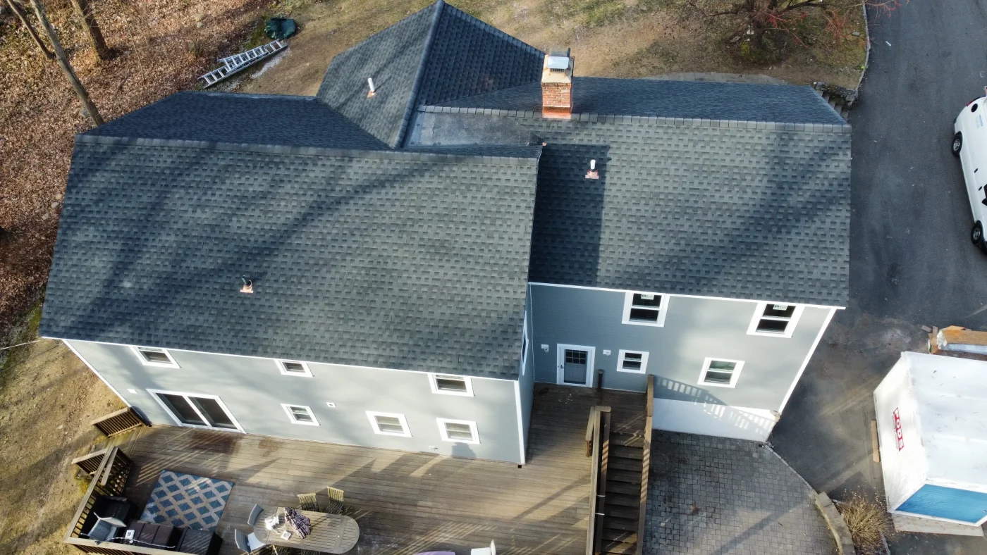 Proven Residential Roof Replacement In Norwalk, CT | Sound Renovation A freshly installed GAF Timberline asphalt roof on a two-story home with clean ridge lines and new flashing.