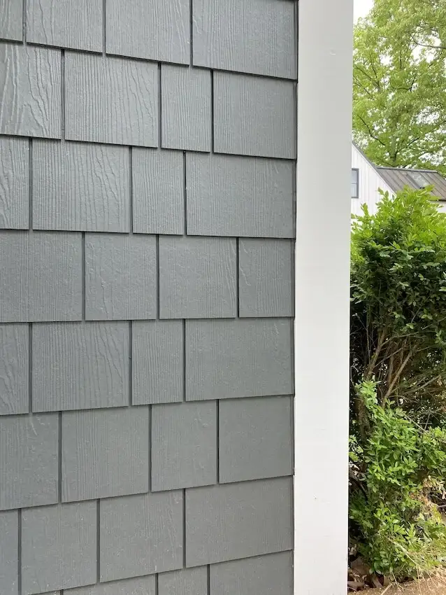 Dark gray siding with white trim installed on a home for a modern look.