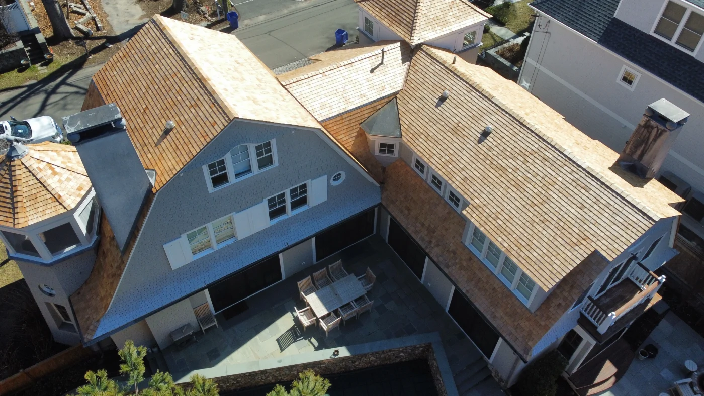 Roofing And Siding Experts | Fairfield County, CT | Sound Renovation An overhead view of the new, hand-nailed cedar roof installed on a large local home.