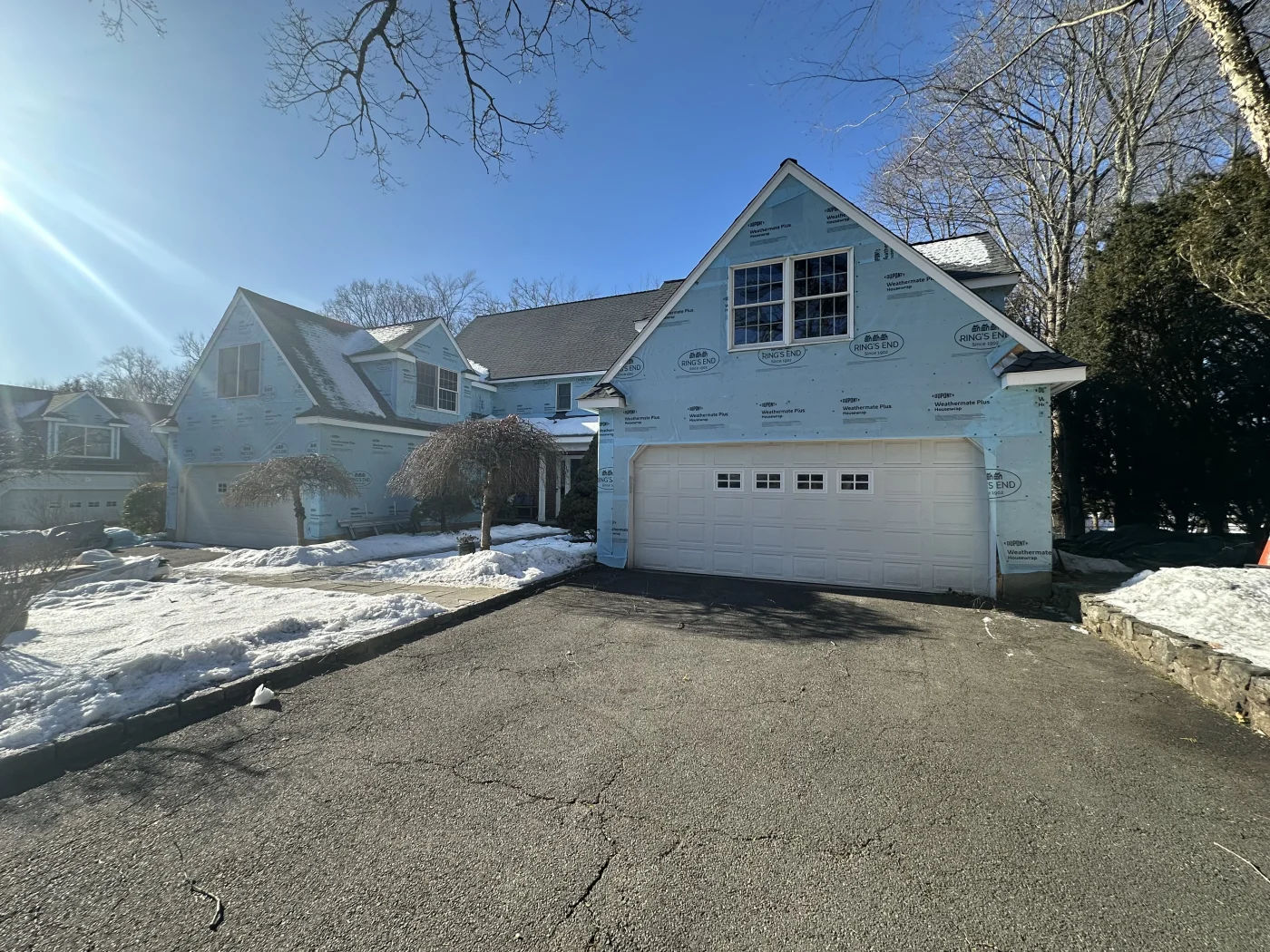 A siding installation taking place with snow on the ground, but it doesn’t slow down Sound Renovation.