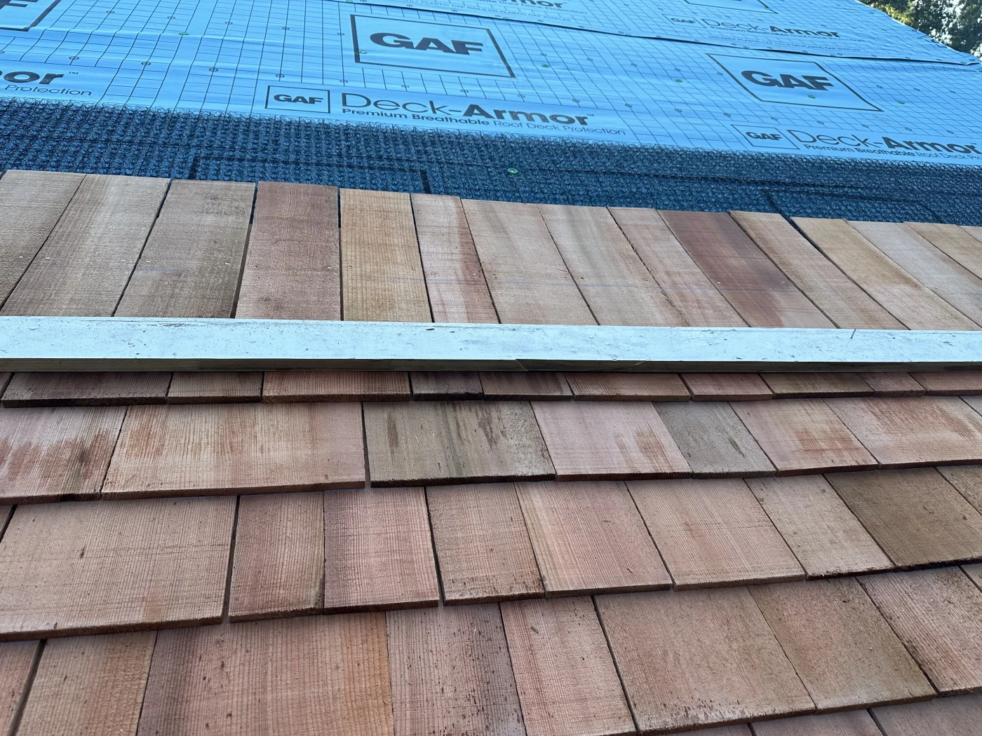 Strong Residential Roof Replacement In Norwalk, CT | Sound Renovation A close-up view of a roof being replaced on a home with a GAF underlayment.