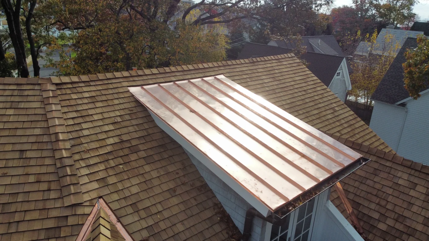 Sturdy Metal Roofing & Fabrication In Weston, CT | Sound Renovation Copper standing seam metal roofing attached to a home to complete the roof.