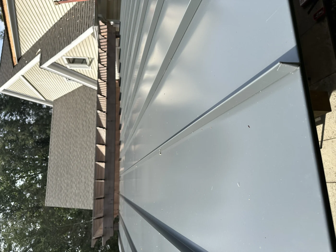 A dark gray standing seam metal roof installed on a structure.
