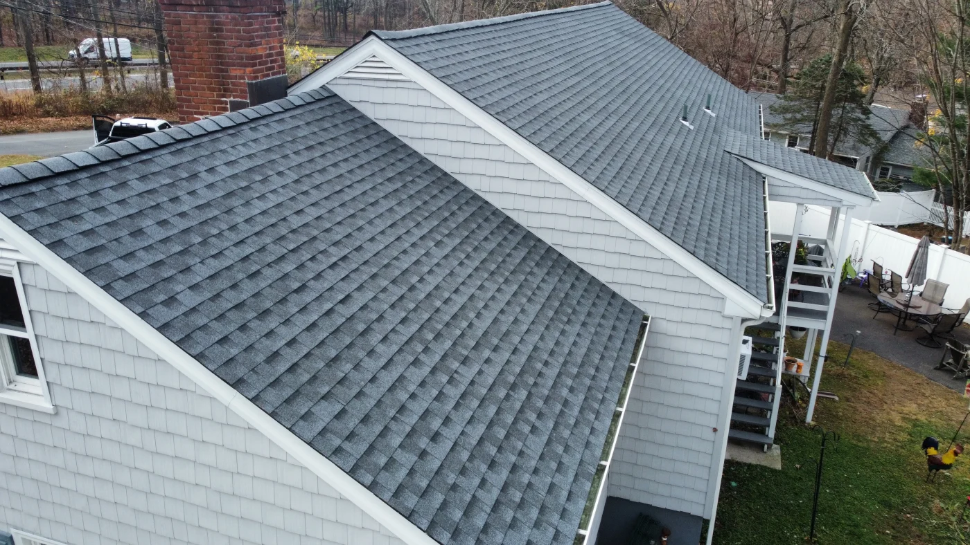 A close-up view of a dark gray asphalt roof installed on a home.