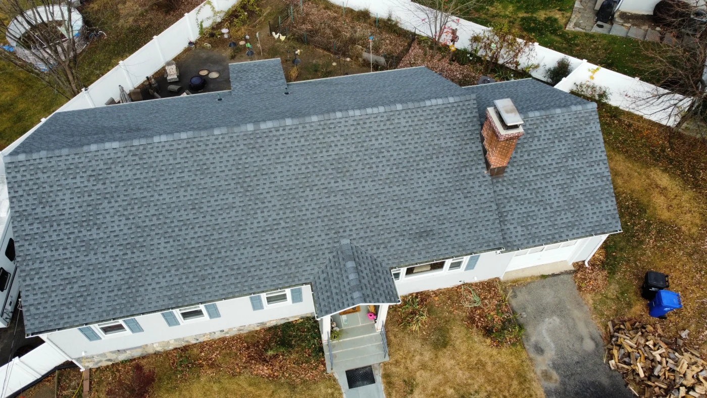 An aerial view of a dark gray asphalt roof that has been installed on a single-level home.